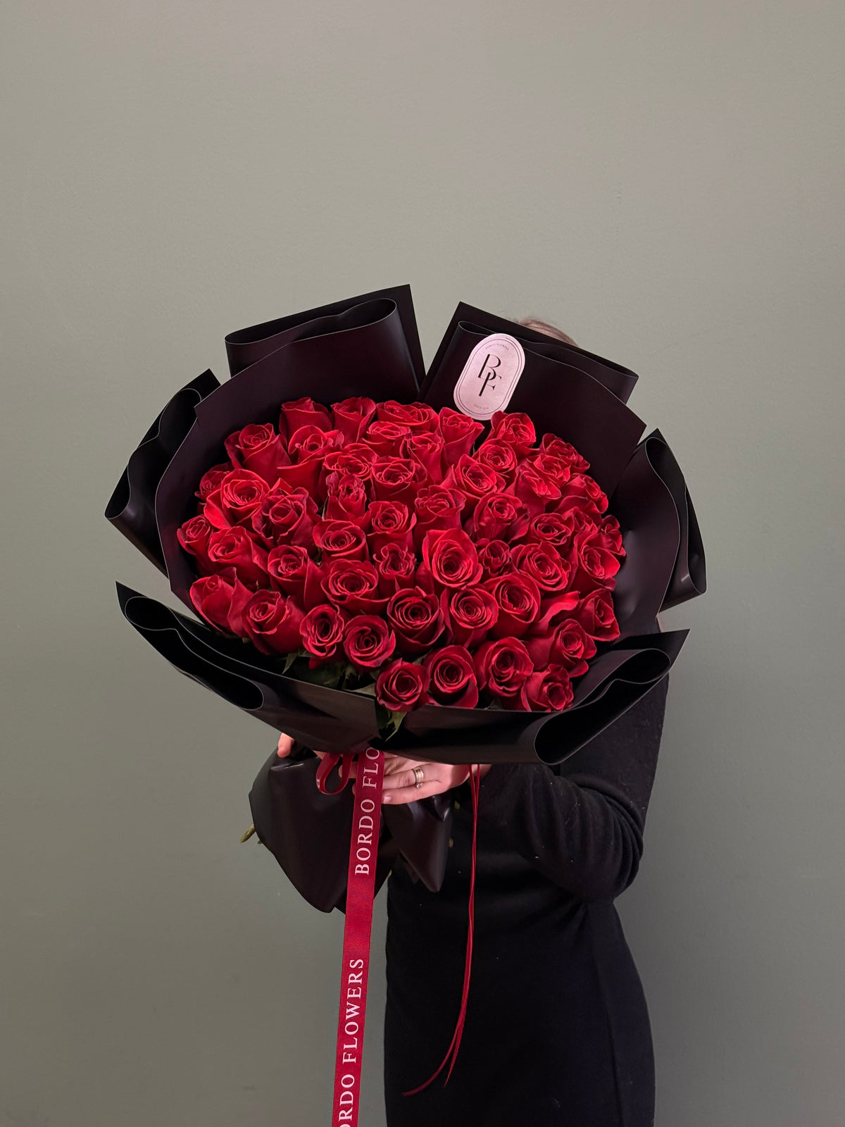 Luxury 50-red-rose bouquet wrapped with signature ribbon
