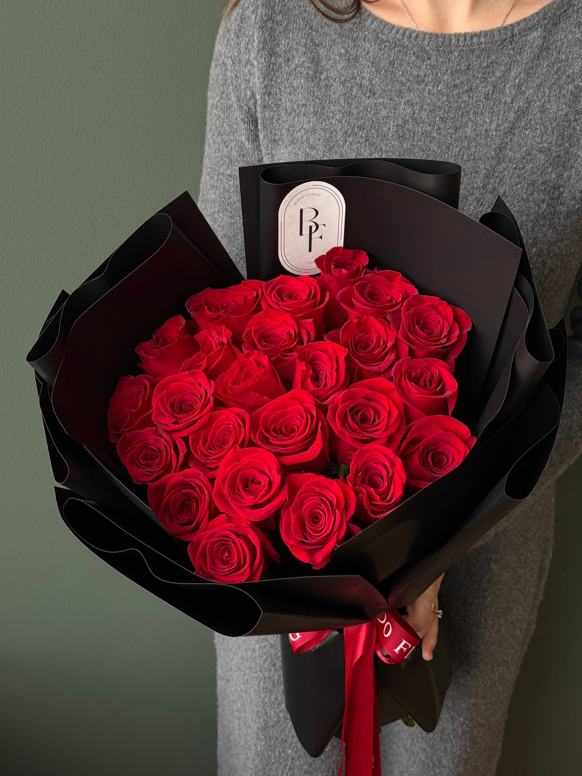 24 Ecuadorian red roses wrapped in elegant paper with signature ribbon