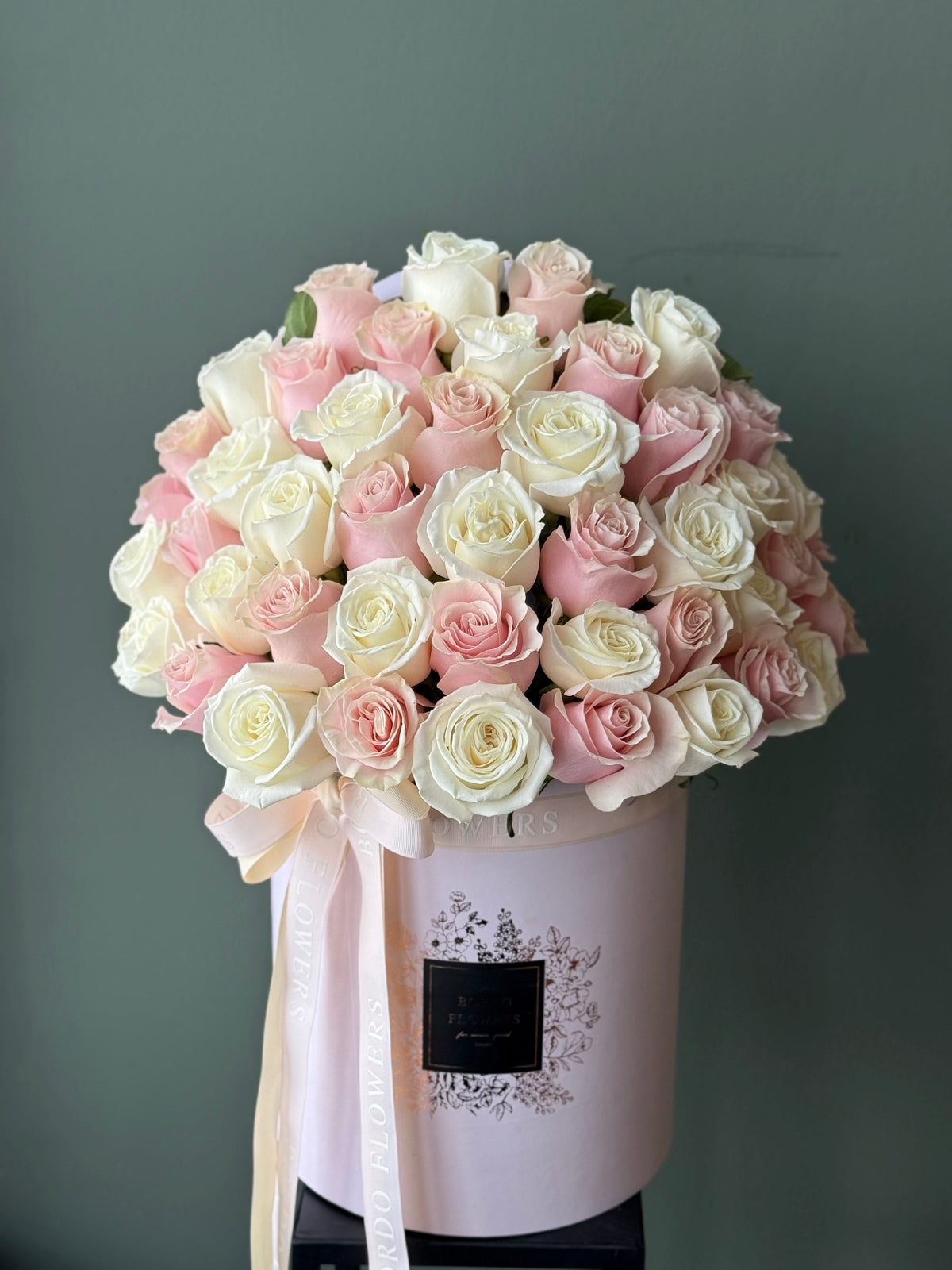 50 roses arranged in a full front-facing luxury flower box