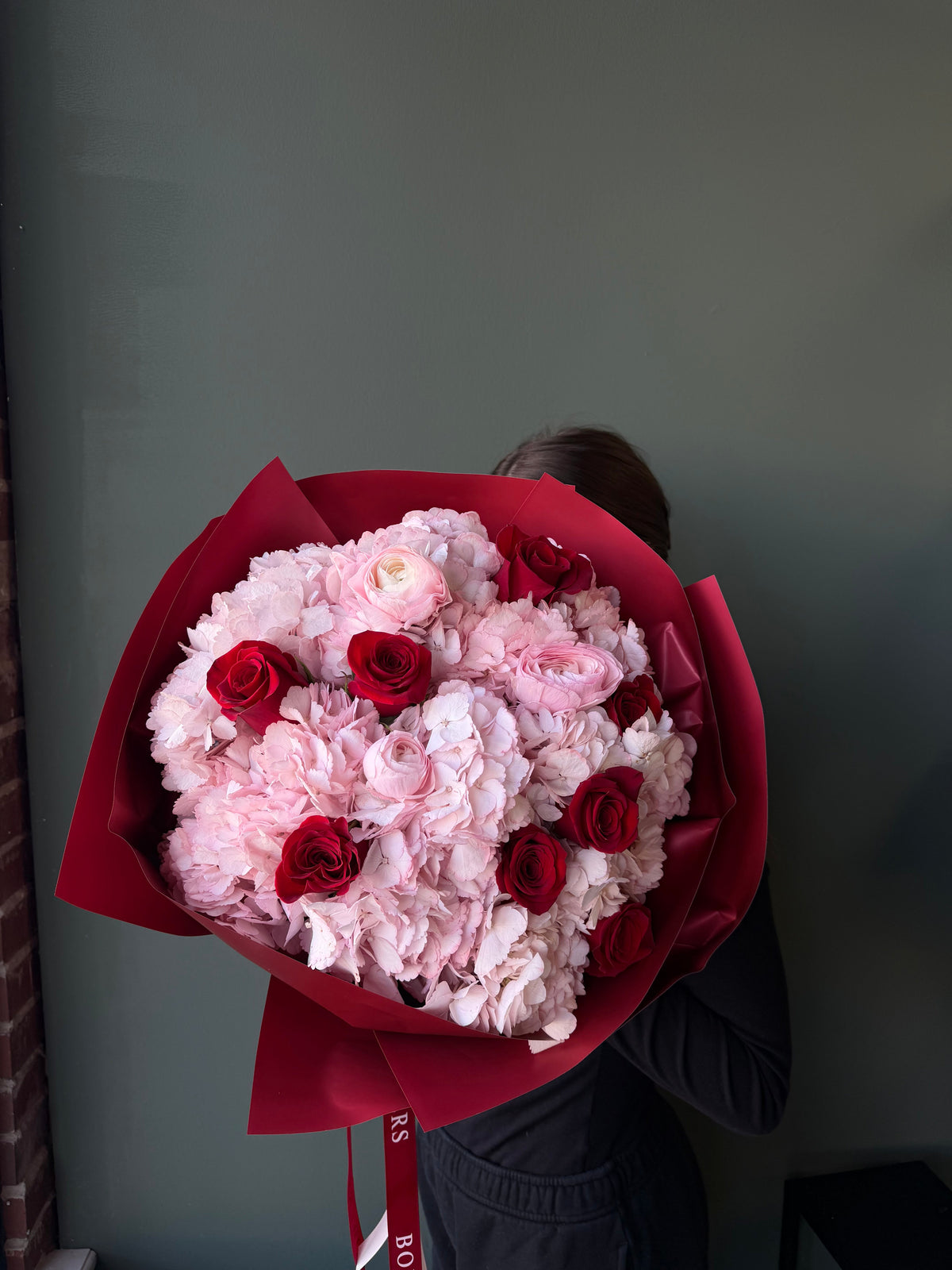 "Be Mine" bouquet: pink hydrangeas, red roses, and delicate ranunculuses in a romantic rounded design. Includes carry bag and aqua box. Dallas TX delivery.