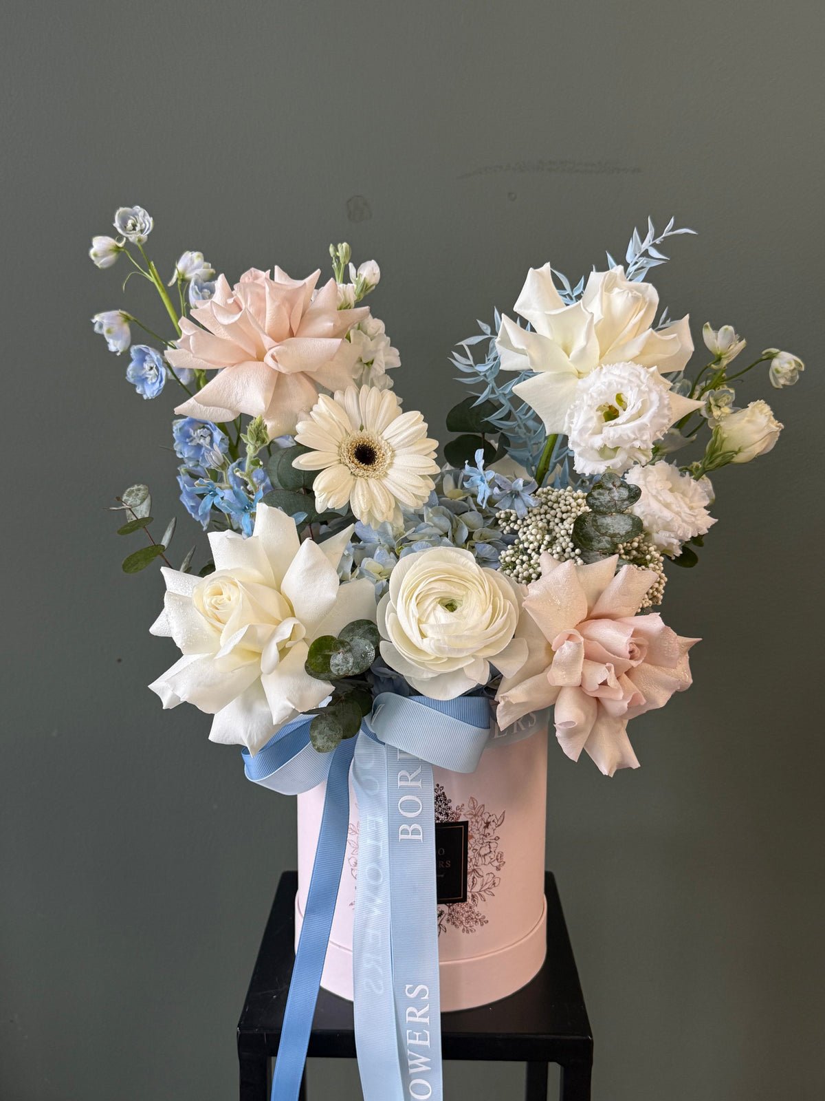 “Sun and Sea” white and yellow floral arrangement in a blue box