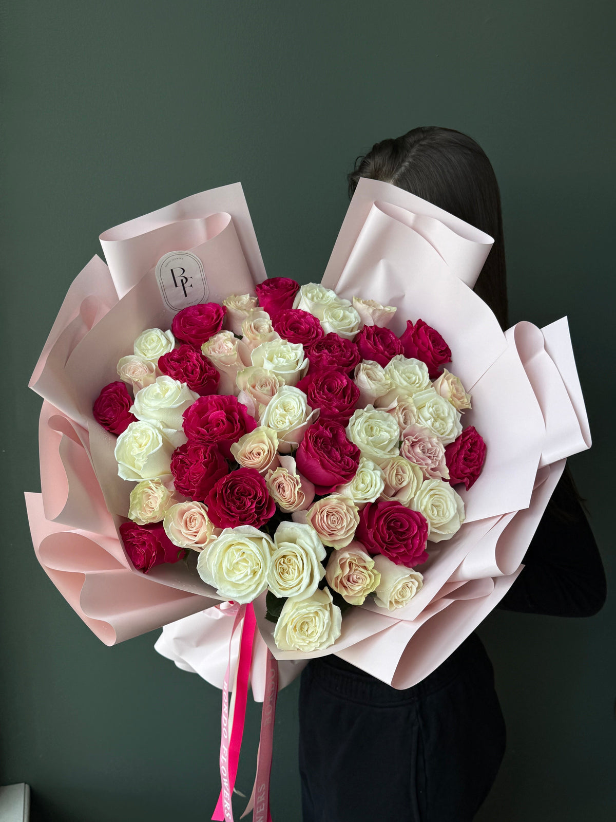 50 colorful roses wrapped in elegant paper with signature ribbon