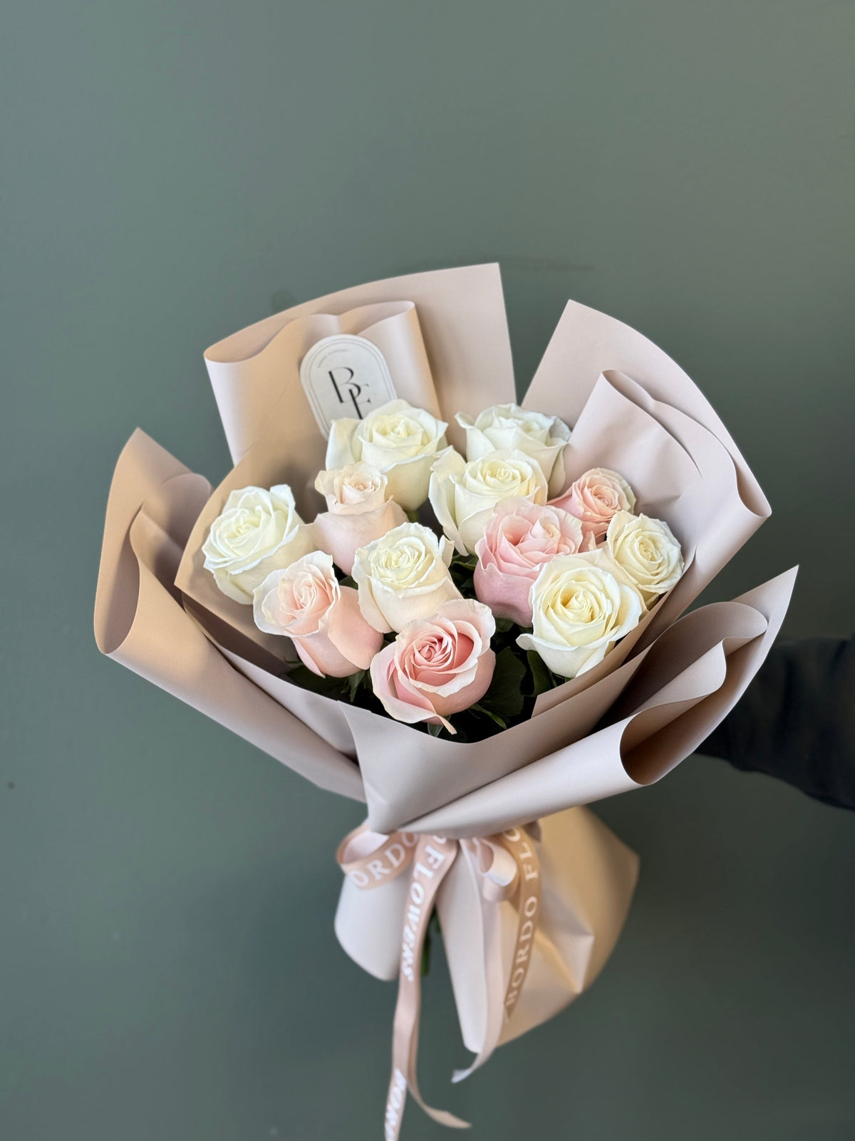 12 premium Ecuadorian roses wrapped in elegant paper, elegant fresh flower arrangement for same-day delivery in Dallas