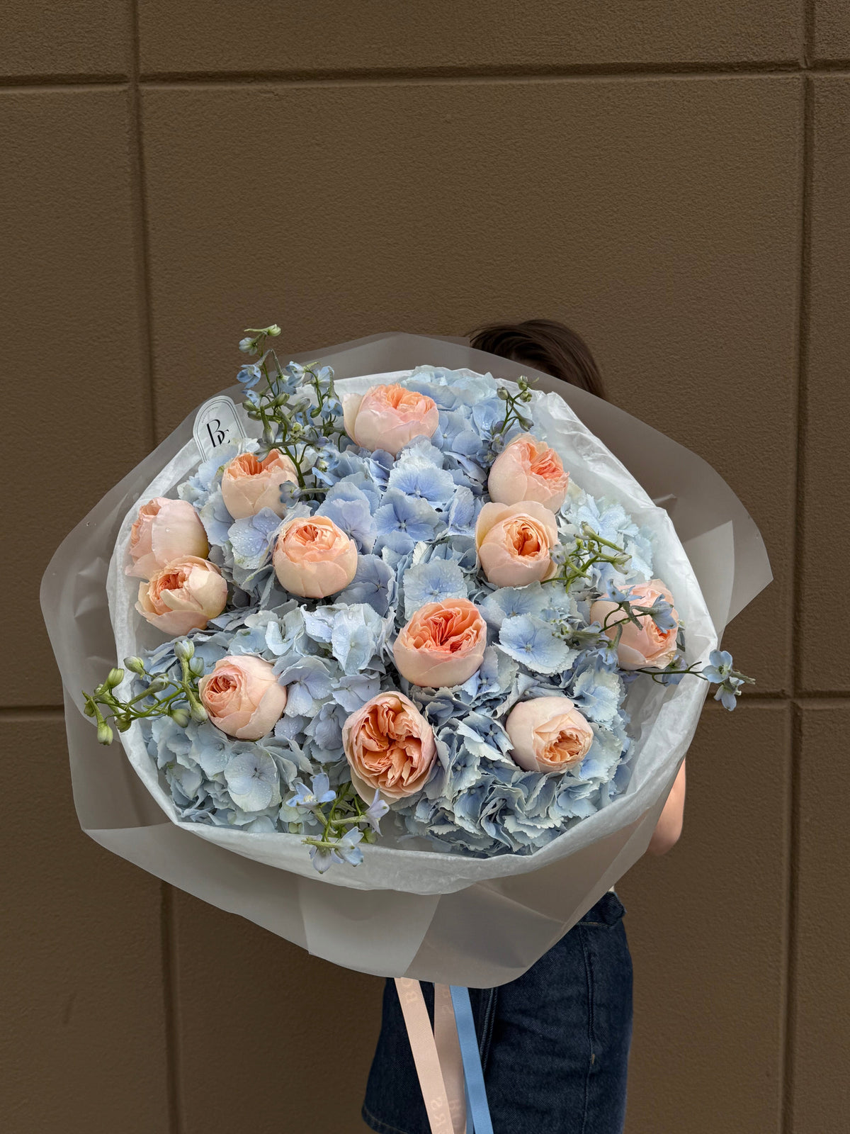 Love From The First Sight bouquet featuring blue Dutch hydrangeas and Juliet garden roses