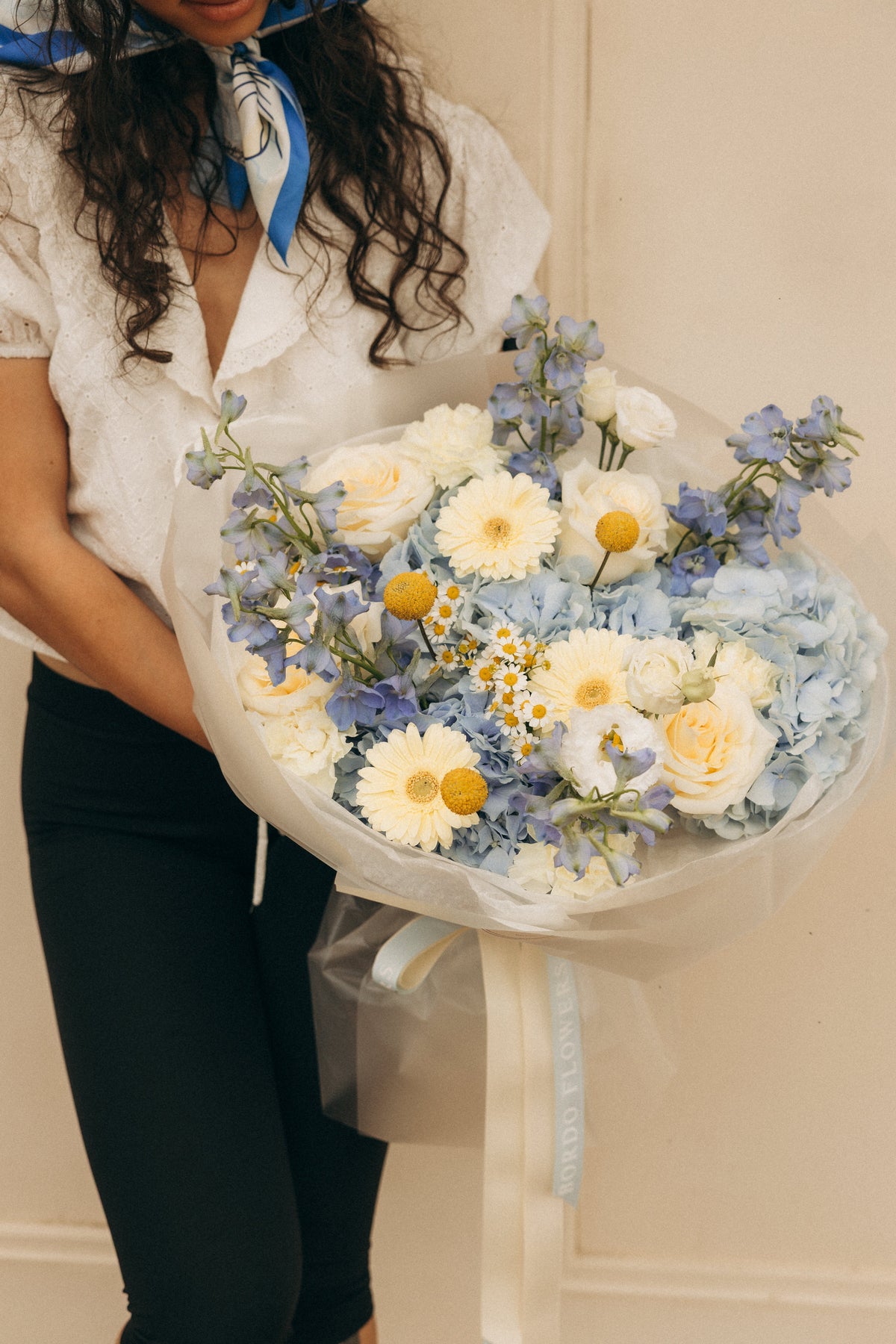 Dolce Vita summer bouquet featuring blue Dutch hydrangeas and yellow gerberas