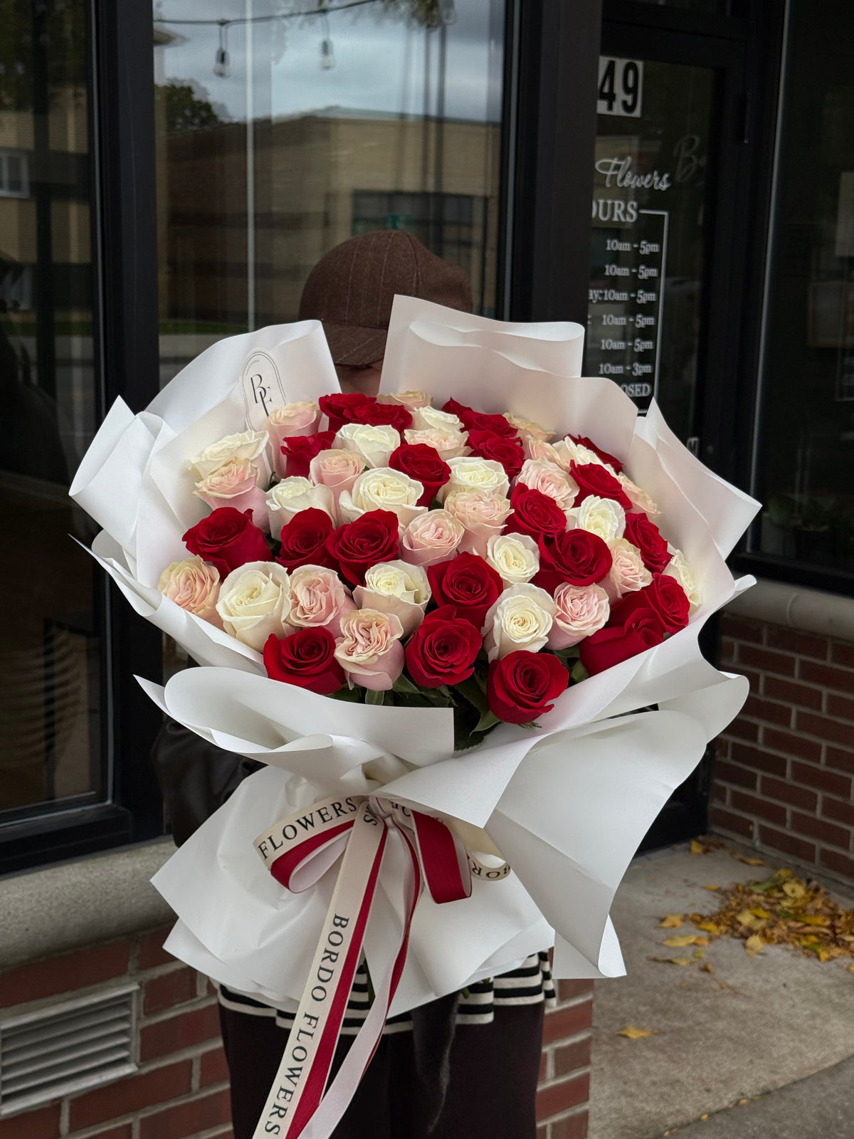 101 colorful roses wrapped in elegant paper with signature ribbon