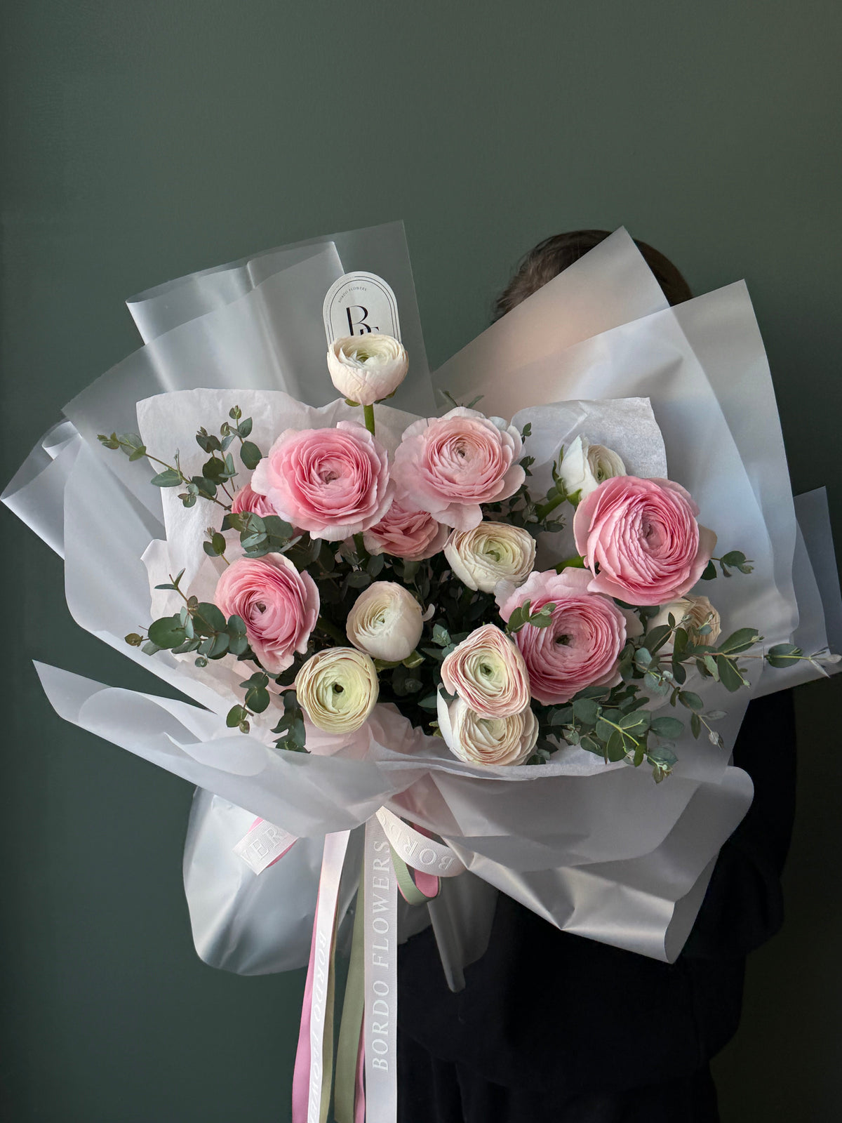 "Ballerine" bouquet: 15 assorted ranunculuses and eucalyptus in a modern asymmetrical design. Airy, premium floral art. Design confirmed before Dallas TX delivery.