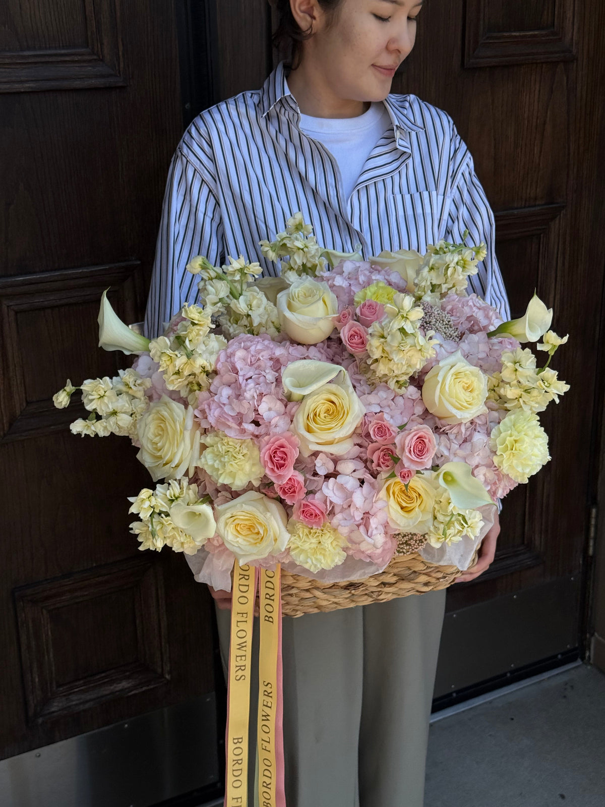 Romantic pink flower basket with buttercream roses and freesia