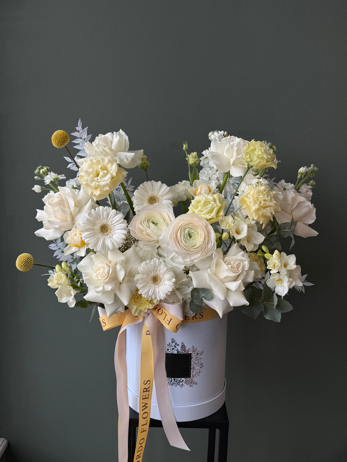 "Sun and Sea" blue box: soft blend of white and buttery yellow flowers inspired by coastal light. Wet floral sponge included. Delivery in Dallas TX.
