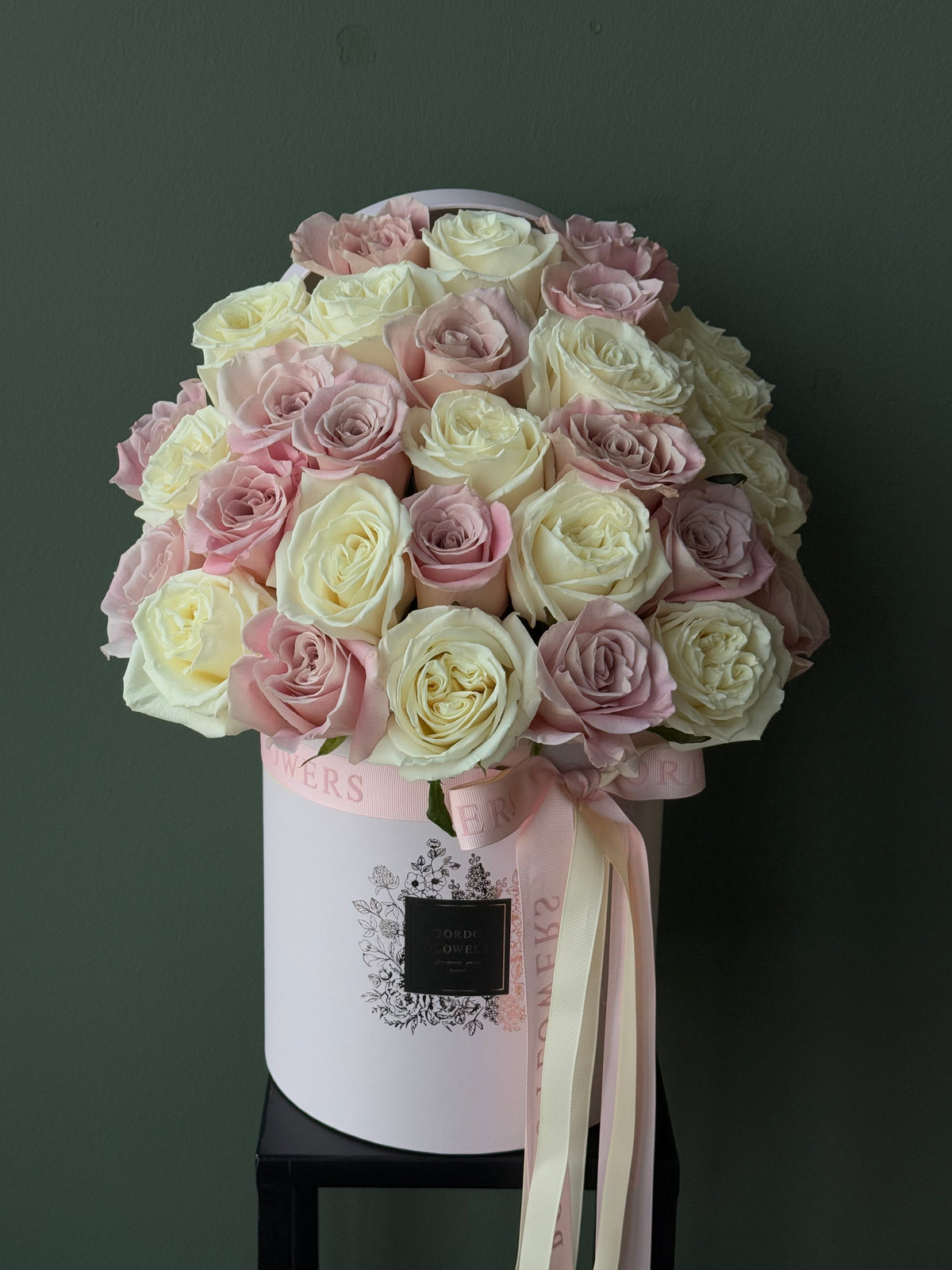 33 premium roses arranged in an elegant front-facing floral box