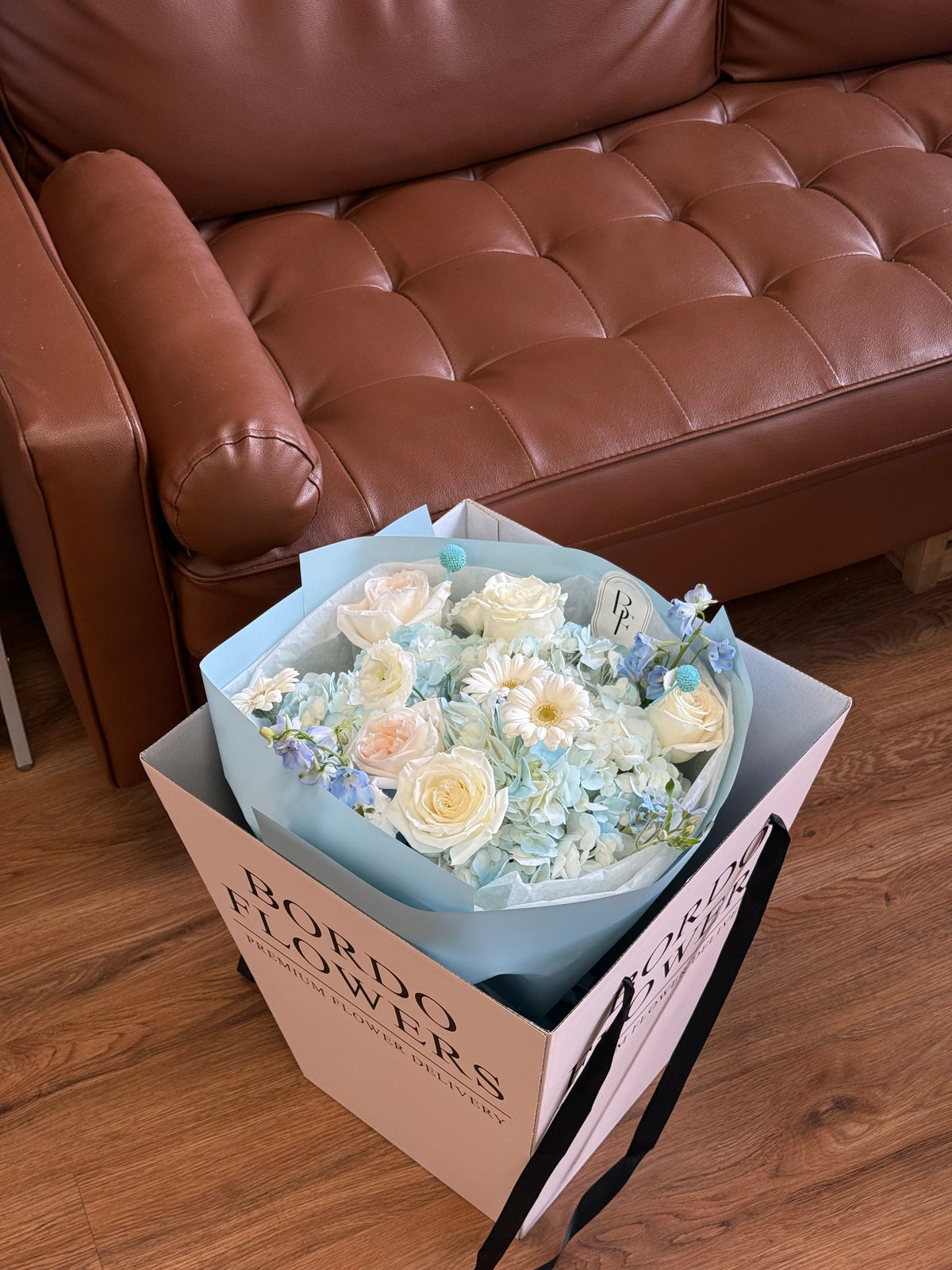 Delicate blue and white floral bouquet with ribbon by Bordo Flowers