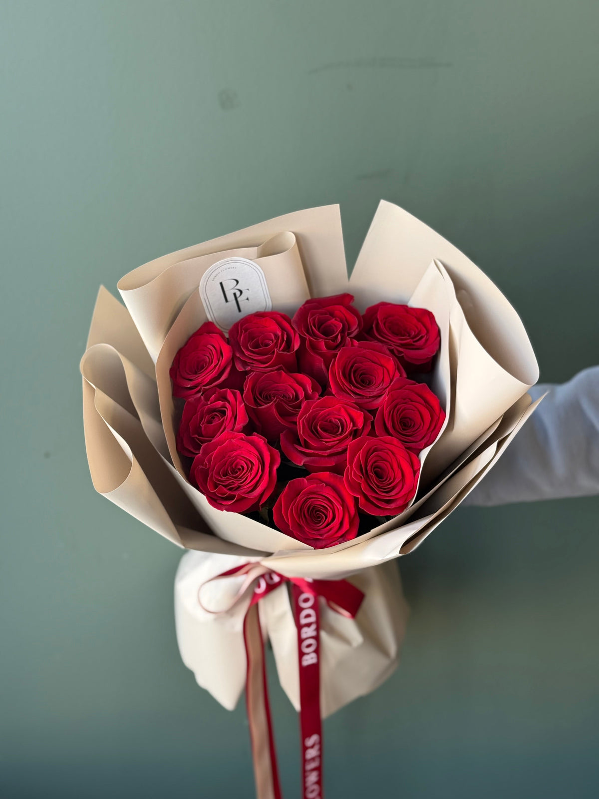 Dozen of red roses: 12 premium stems from Ecuador with signature ribbon. Includes greeting card and care instructions. Classic, high-end floral gift in Dallas TX.